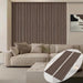 Beige sofa with striped wall and coffee table in a living room setting