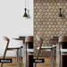 Before and after effect of installing hexagonal acoustic wood panels in dining area