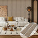 Modern living room with a sofa, coffee table, and decorative elements.